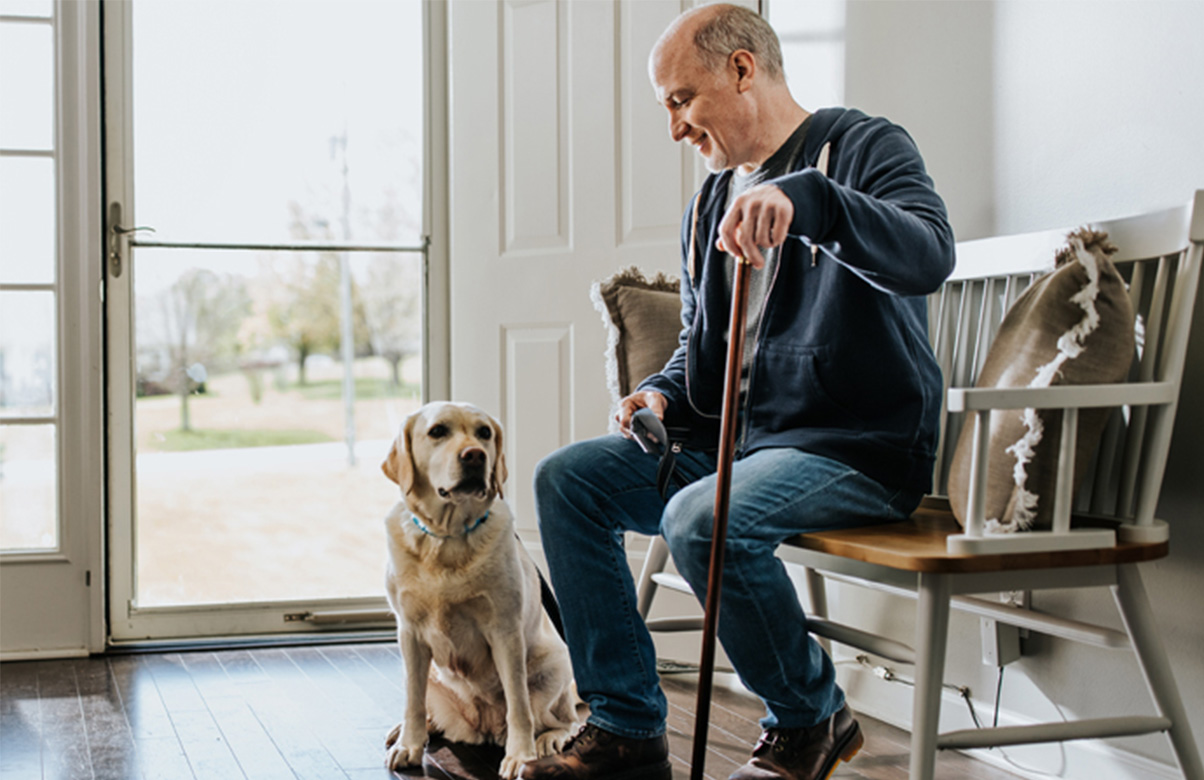 Older man and his dog getting ready for a walk.