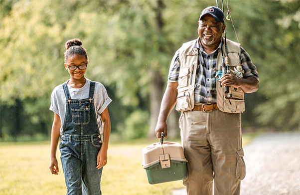 A grandfather and his granddaughter going on a fishing trip.